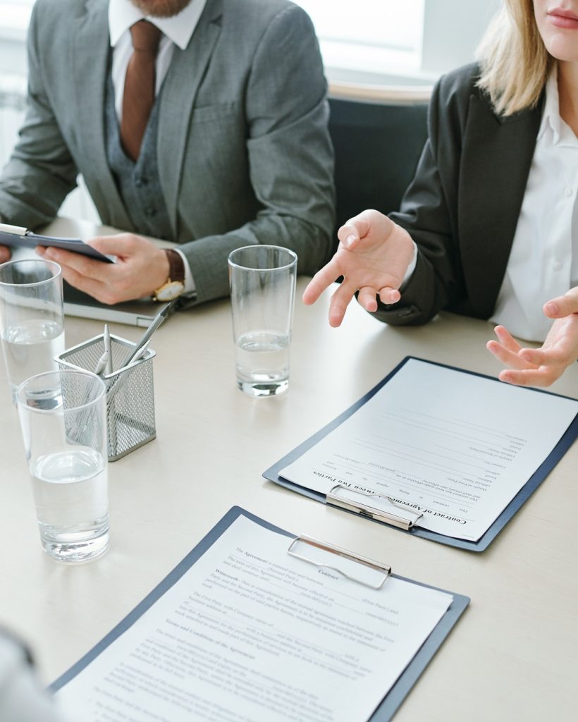 hands-of-young-businesswoman-in-formalwear-over-contract-or-financial-documents.jpg